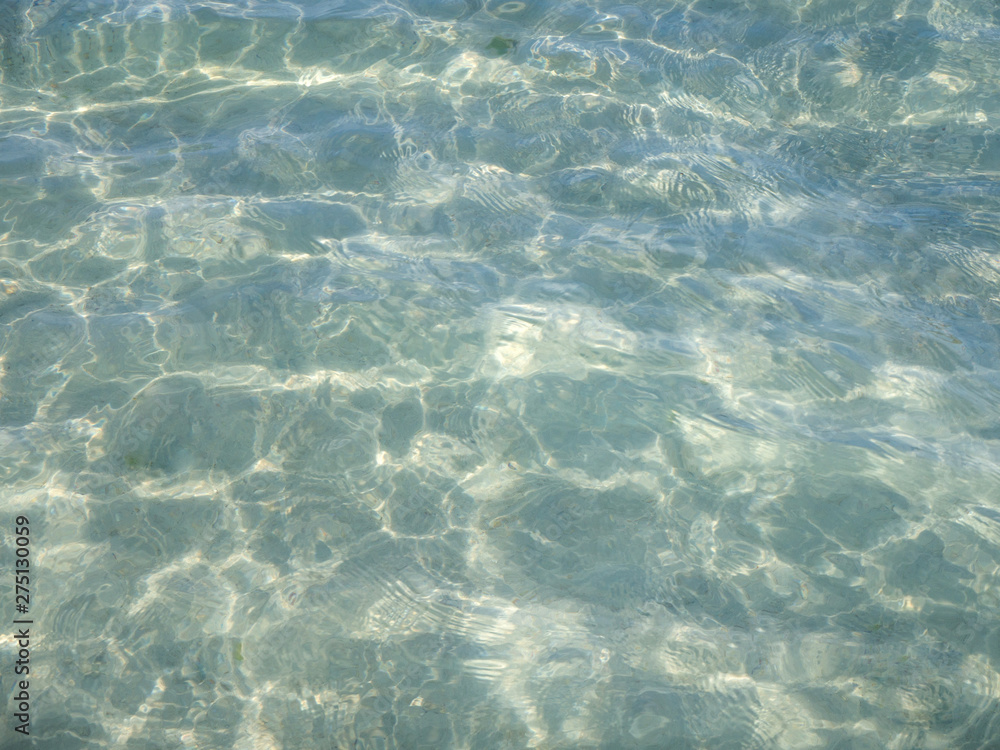 clear water with shadows from the waves in the sand clear water with shadows from the waves in the sand