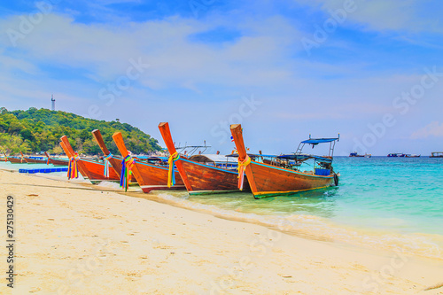 Long tailed boat at kho lipe satun Thailand/Fishing boat on the sea and blue sky background at kho lipe satun Thailand/Tropical beach kho lipe satun Thailand wooden long tailed boat on the sea/ 