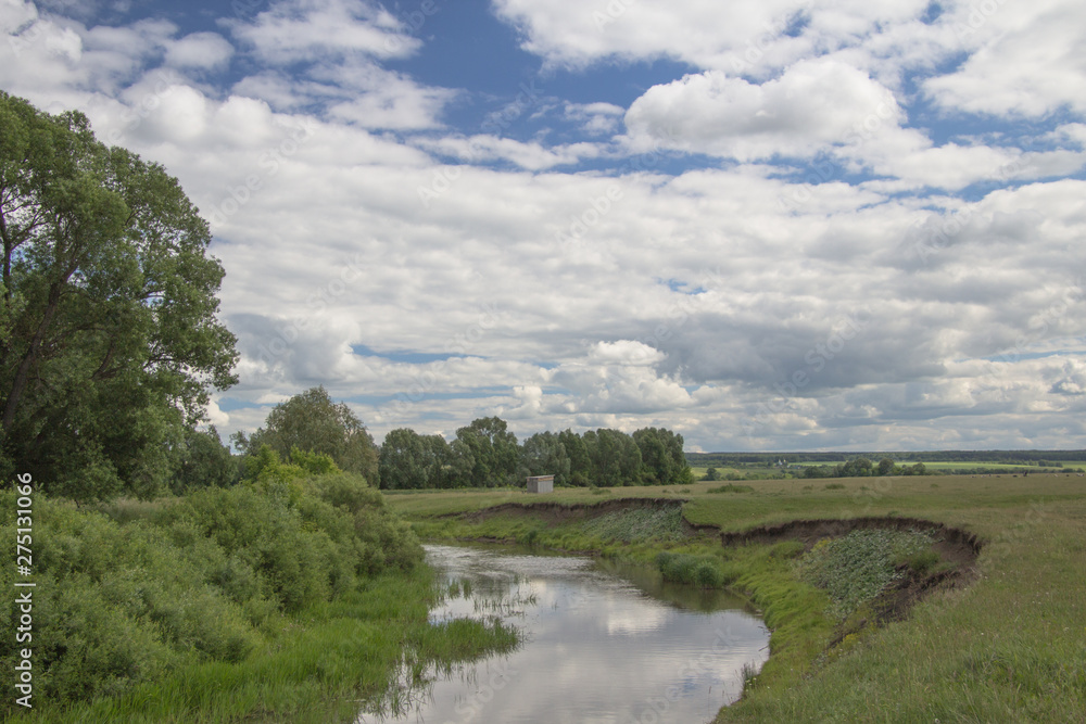 summer landscape overlooking the river under a blue sky and white clouds in Chuvashia