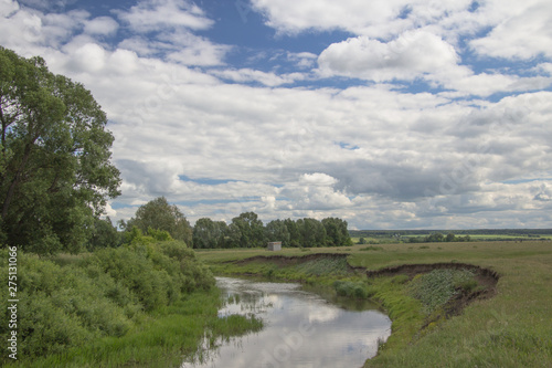 summer landscape overlooking the river under a blue sky and white clouds in Chuvashia