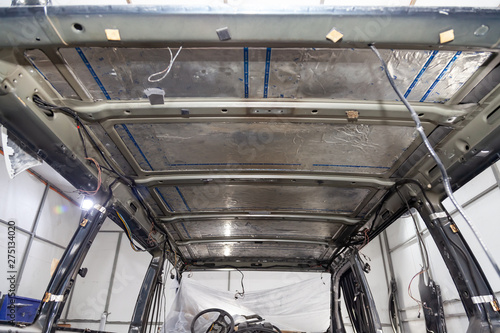 Wallpaper Mural Tuning the car in a van bus body with three layers of noise insulation on the metal roof. Sound and vibration isolation using soft and rubber material with a car breakdown. Auto service undustry. Torontodigital.ca
