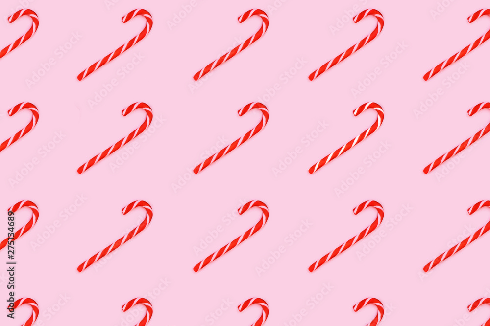 Pattern made from Christmas candy canes isolated on pink. Pattern made from Christmas candy canes isolated on pink.