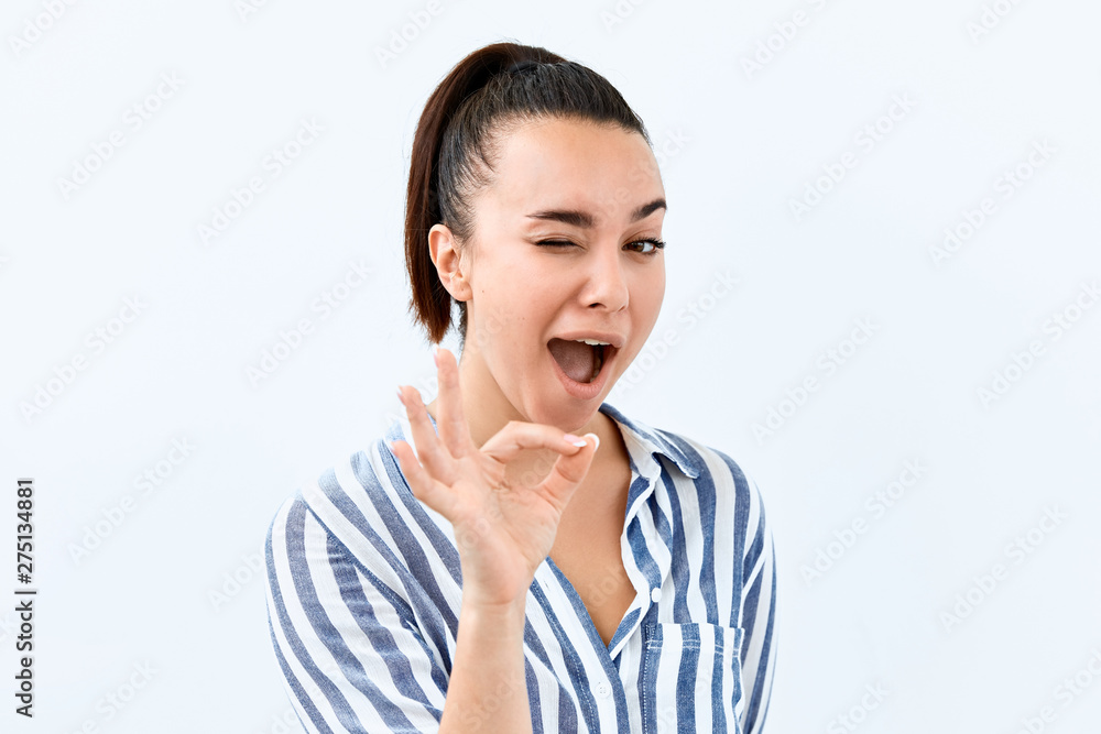 Okay symbol. Portrait of Brunette girl who a showing agree and approval sing. Okay symbol. Portrait of Brunette girl who a showing agree and approval sing.