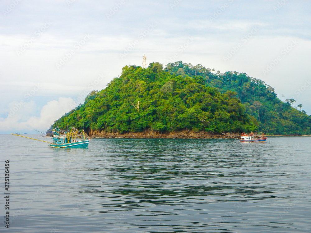 Fototapeta premium Fishermen Worked Out Are Job Using Long Tail Boats to Catch Fish in The Sea.