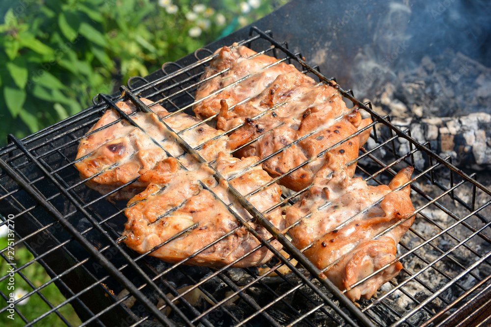 Delicious chicken thighs with spices on the grill