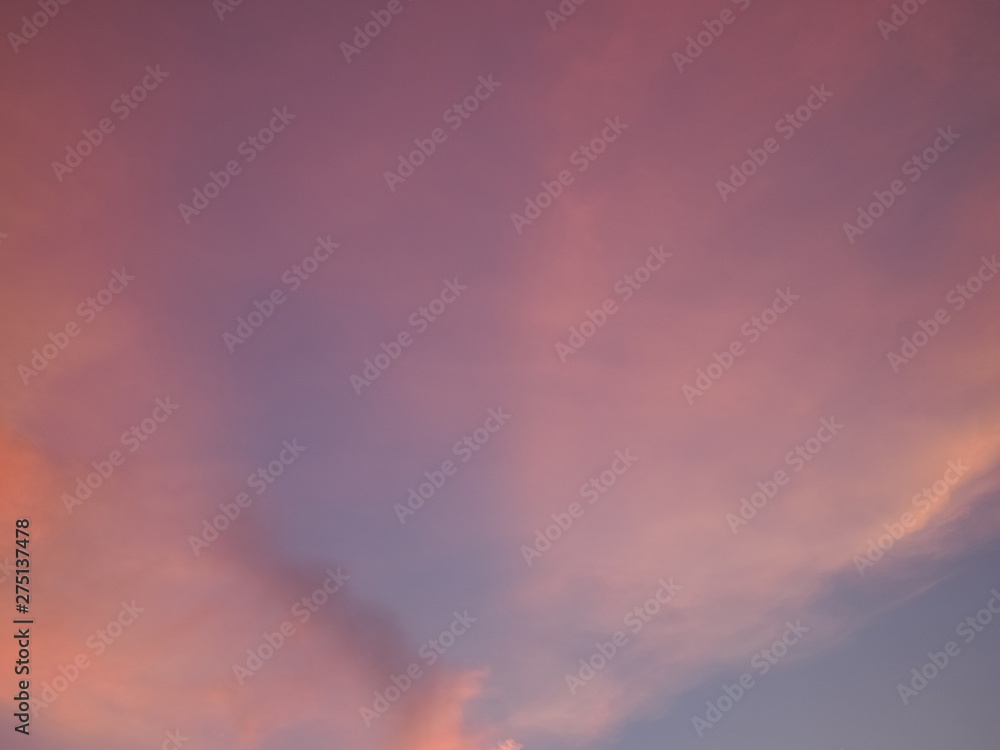 Twilight cloudy sky background, view of cloudy sky painted with red sun light after sunset. Twilight cloudy sky background, view of cloudy sky painted with red sun light after sunset.