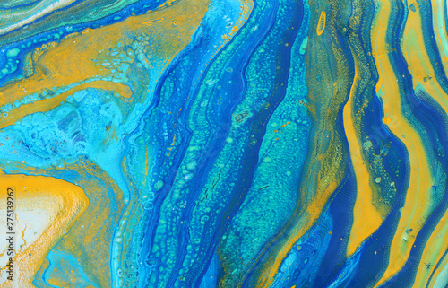 photography of abstract marbleized effect background. Blue, mint, yellow and white creative colors. Beautiful paint.