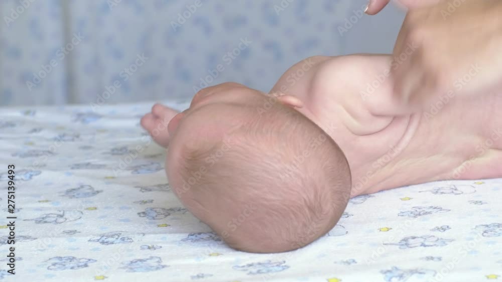 Shot of massage professional therapist does for two months old baby girl child rehabilitation massage Shot of massage professional therapist does for two months old baby girl child rehabilitation massage