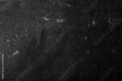white dust and scratches on a black background. The texture of dirt on the glass.