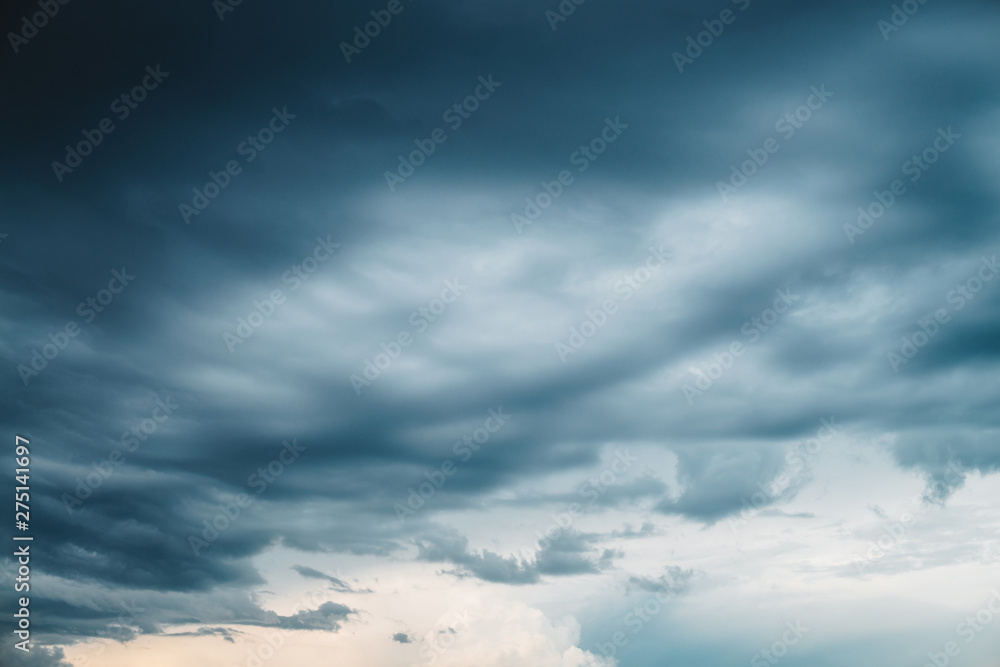 Dramatic cloudscape. Sunny light through dark heavy thunderstorm clouds before rain. Overcast rainy bad weather. Storm warning. Natural gray background of cumulonimbus. Sunlight in stormy cloudy sky. Dramatic cloudscape. Sunny light through dark heavy thunderstorm clouds before rain. Overcast rainy bad weather. Storm warning. Natural gray background of cumulonimbus. Sunlight in stormy cloudy sky.