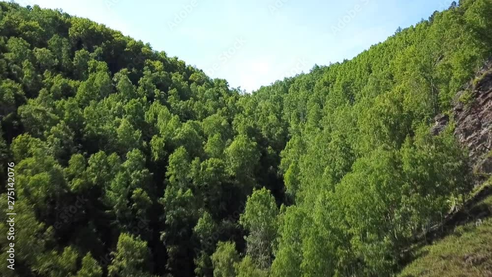 Lake Baikal oldest. Railways Russia Siberia. Mountains pine forest summer sun shines blue water. Beautiful aerial follow above lake Lake Baikal oldest. Railways Russia Siberia. Mountains pine forest summer sun shines blue water. Beautiful aerial follow above lake