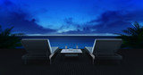 Two wooden loungers on terrace with ocean view and evening sky