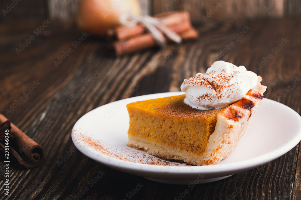 Slices of pumpkin pie with whipped cream, Thanksgiving day dessert Slices of pumpkin pie with whipped cream, Thanksgiving day dessert