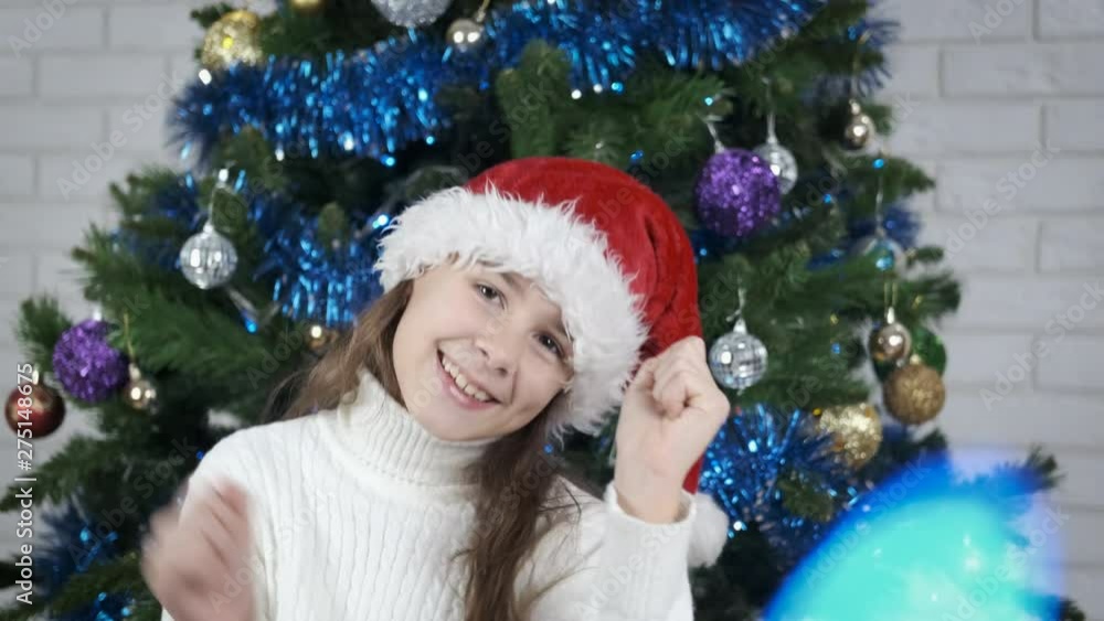 Happy girl dancing on New Year night. Cheerful little girl having fun at Christmas. Happy girl dancing on New Year night. Cheerful little girl having fun at Christmas.