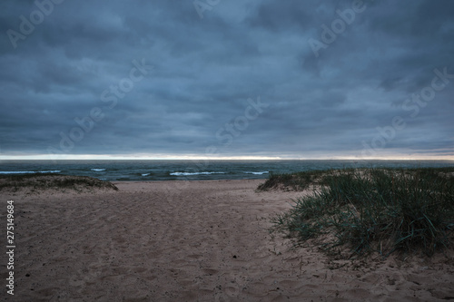 Wallpaper Mural dark clouds from storms over the beach with grass hills Torontodigital.ca