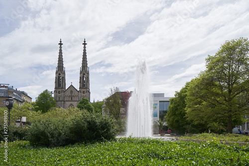 Beautiful green park with a fountain, next to the Evangelical Church in Europe, augustaplatz and fountain in Baden Baden photo