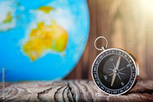 Travel compass and earth globus on wooden background. Journey, adventure lifestyle.Road to home.Trip.