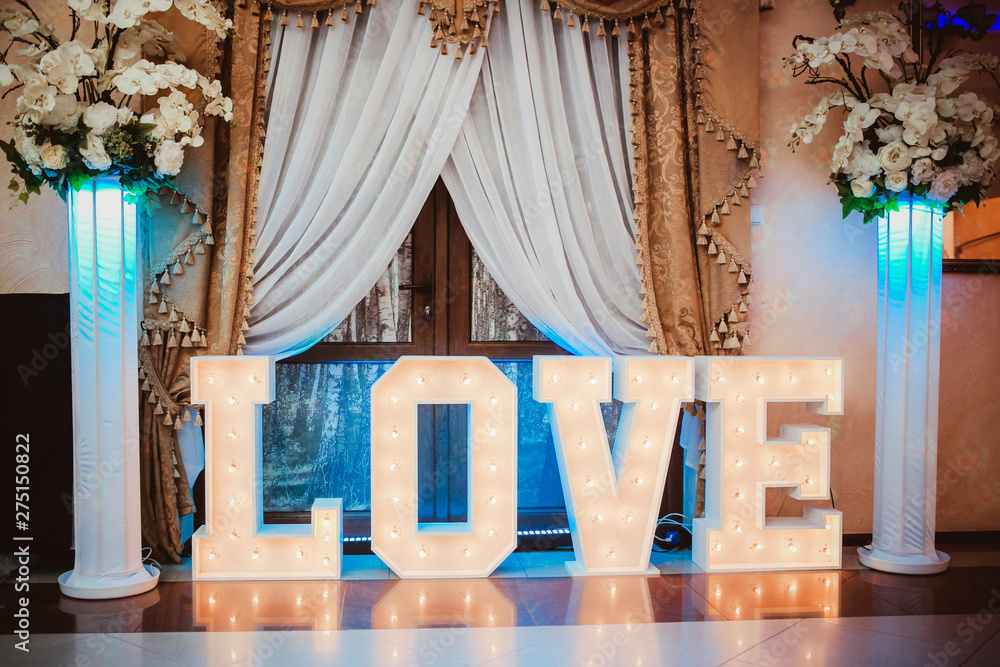 Wooden glowing love text letters. Rustic wedding dance floor lamp. - obrazy, fototapety, plakaty 