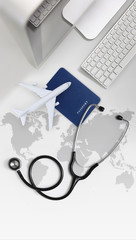 international medical travel insurance concept, stethoscope, passport, computer and airplane on desk office with global map