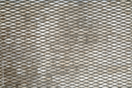Textured background, metal mesh with the same cells.