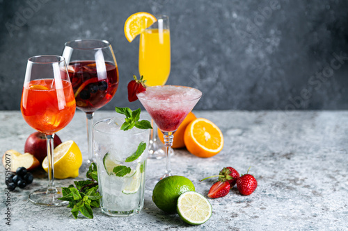 Selection of refreshing summer drinks - mojito, sangria, mimosa, aperol, martini, rustic background copy space