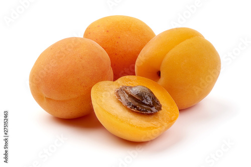 Fresh apricot fruits with juicy half, ripe nectarines, close-up, isolated on white background