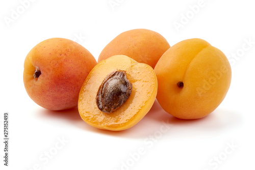 Sweet apricots with juicy half, ripe nectarines, close-up, isolated on white background