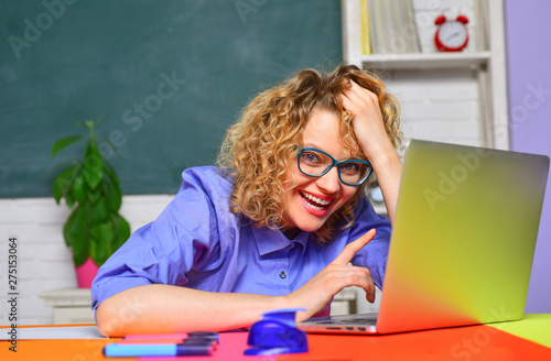 Back to school. Smiling teacher working with laptop. Learning and education concept. Student and tutoring education concept. Smiling teacher in glasses. Homework. E-learning.