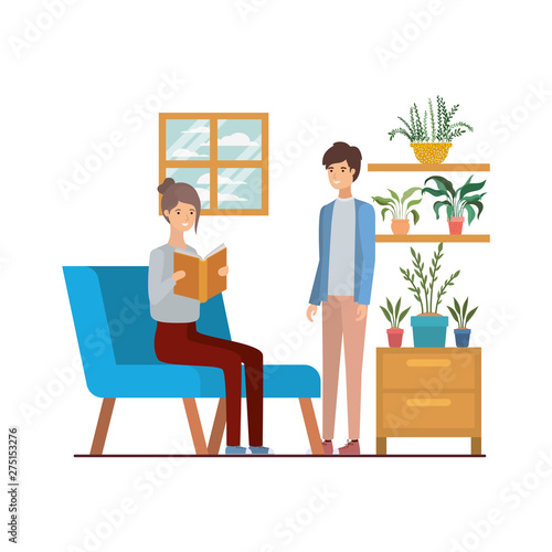 couple with book in hands in living room