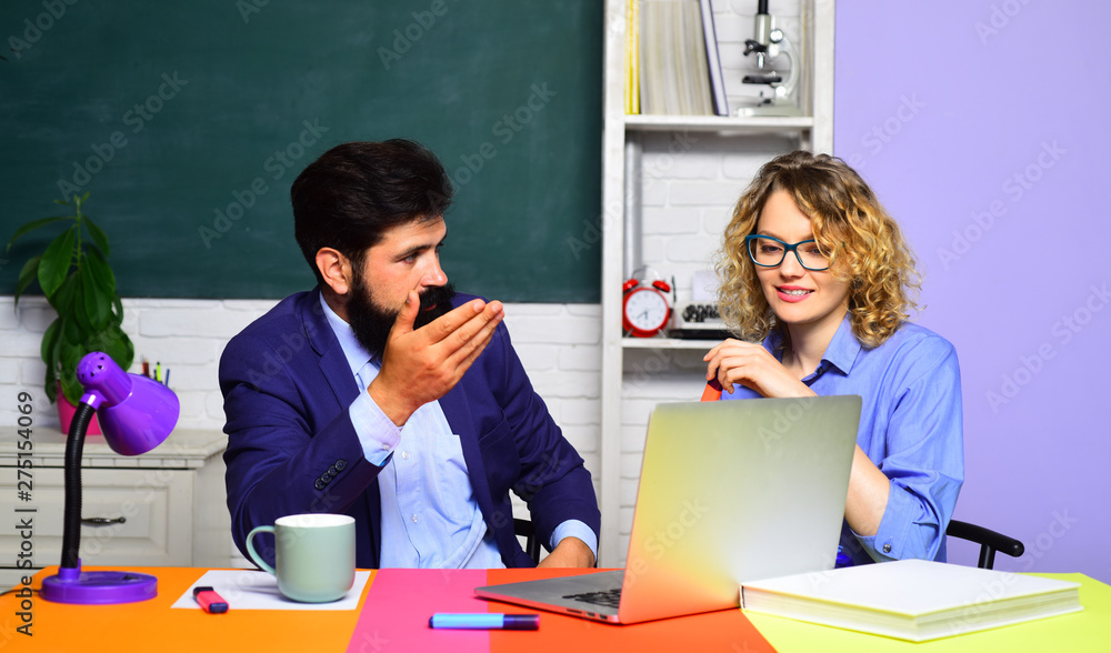 Couple of teachers in classroom. World teachers day. Homework. School job. High school concept. Student in college. Bearded professor. Couple of teachers in classroom. World teachers day. Homework. School job. High school concept. Student in college. Bearded professor.