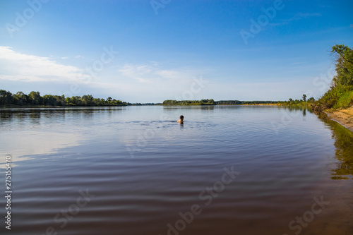 A person leads a healthy lifestyle and swims in the river © Taras