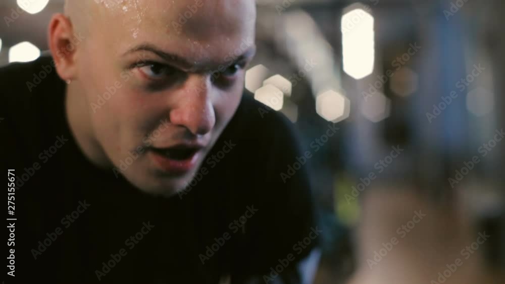 sweat drops on bald guy face breathing deeply exercising in sports club slow motion extreme close view sweat drops on bald guy face breathing deeply exercising in sports club slow motion extreme close view