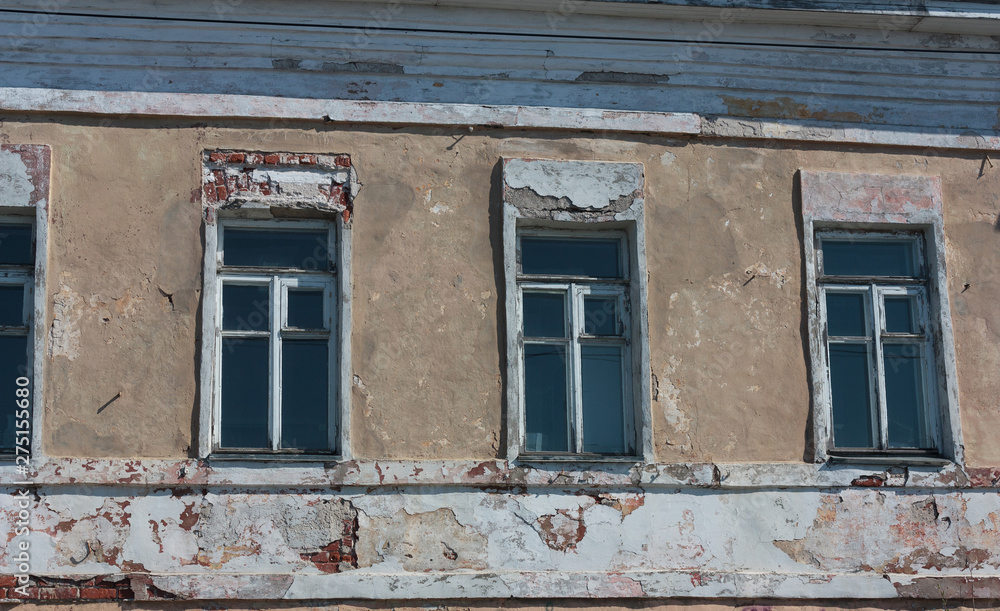 windows in the old wall with broken plaster