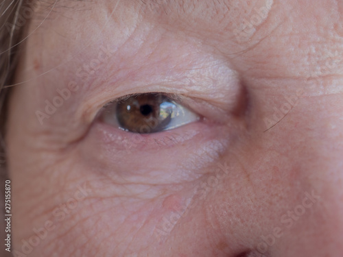 Elderly woman 70 years. Face close up. Eyes, eyebrows, lips, nose. Shallow focus. Village warlock, quack