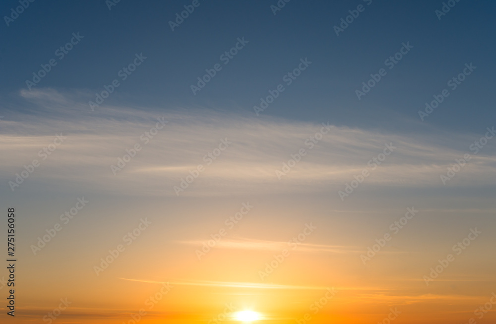 Romantic sunset and cirrus clouds in the blue sky.