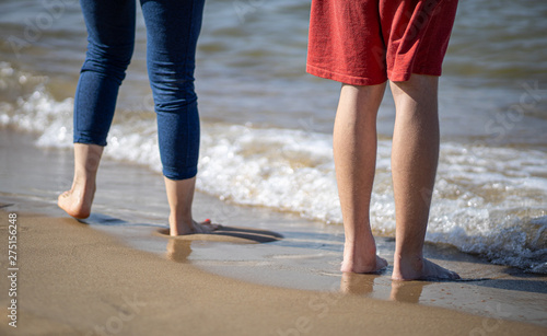 Young couple legs on the beach sand. © Jarek Fethke