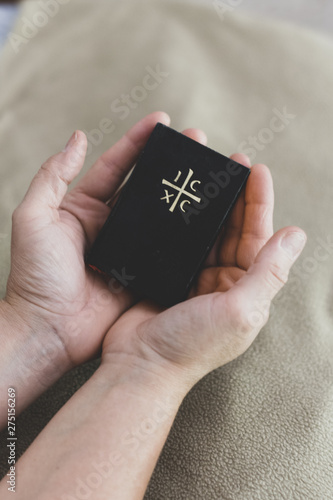 Hands holding a little bible