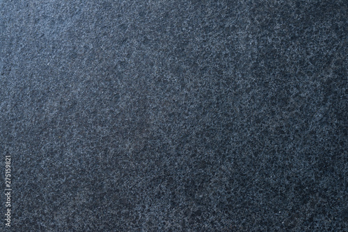 Dark granite. The texture of natural stone slabs for facing the facade of the building.