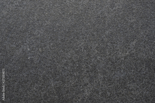 Dark granite. The texture of natural stone slabs for facing the facade of the building.