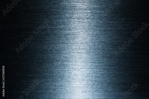 Black metal surface with many small scratches.