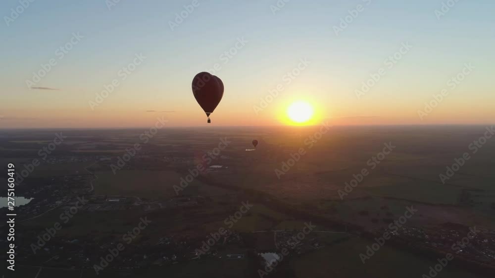 Aerial view Hot air balloon shape heart in sky over field in countryside, beautiful sky and sunset. Aerostat fly over countryside.Aerial footage 4K Aerial view Hot air balloon shape heart in sky over field in countryside, beautiful sky and sunset. Aerostat fly over countryside.Aerial footage 4K