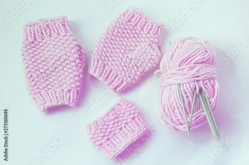 Pink knitted mittens without fingers and cupholder.