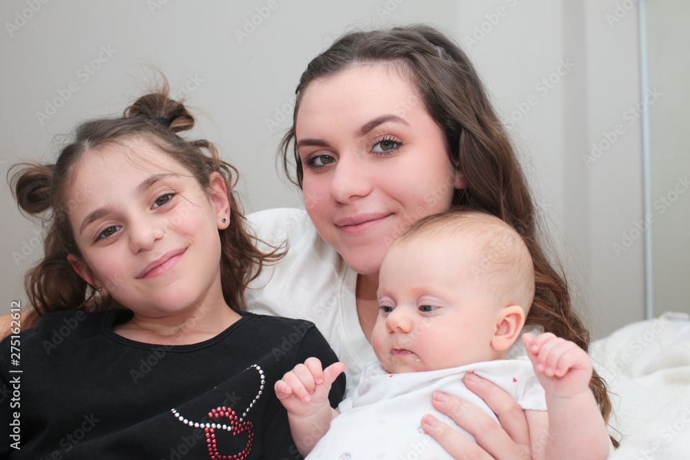 Close up portrait of three beautiful sisters 3 month old baby girl 7