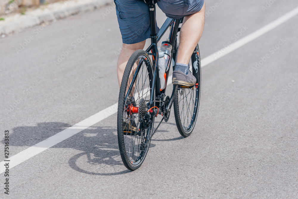 A caucasian male biker rides his bike uphill, wearing professional biking mountain biking gear A caucasian male biker rides his bike uphill, wearing professional biking mountain biking gear