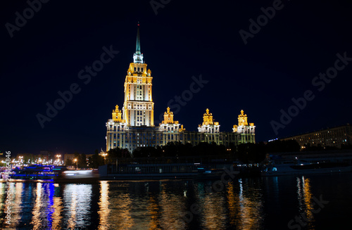 Night city in lights. Building near water. Moscow, Russia