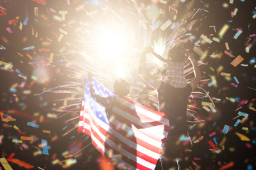 Great holiday of a great country. The celebration of Independence Day in the United States of America. The happy family looks holiday fireworks in the evening sky