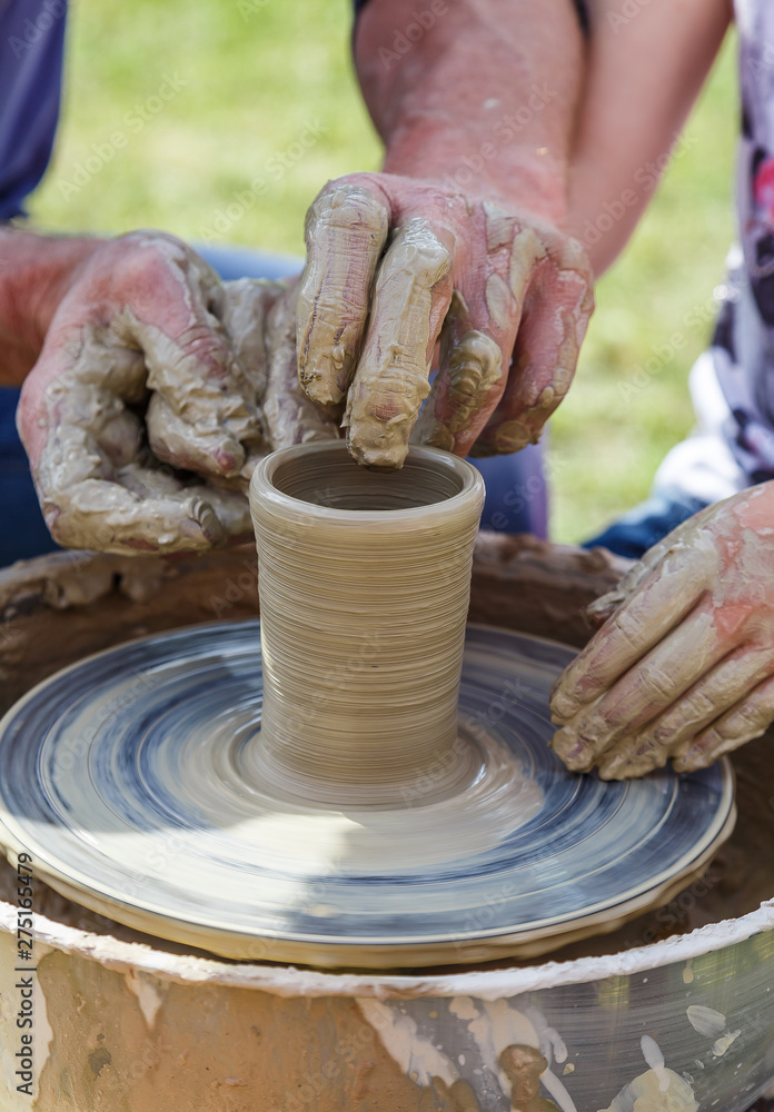 Production of a clay pot on a Potter's wheel.