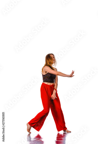 Excited female dancing ballet wearing red pants