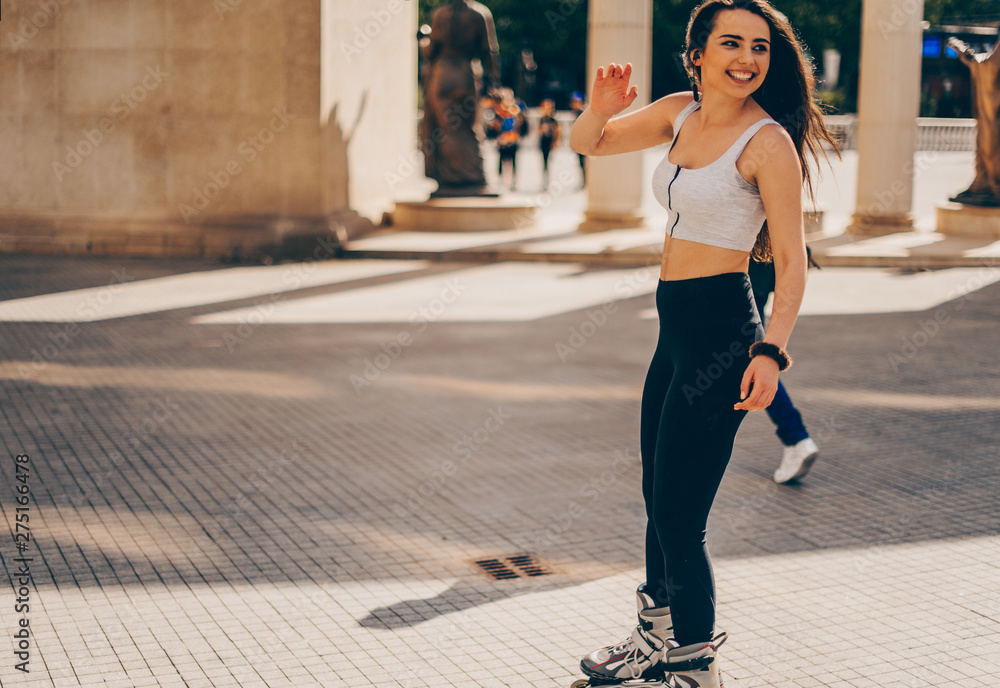 Active woman roller skating in downtown