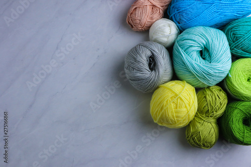 Colorful yarn balls on light grey background